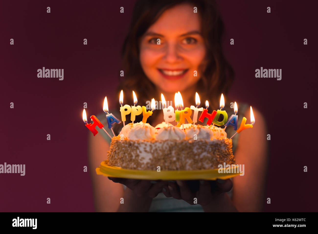 Portrait of pretty girl holding birthday cake Stock Photo - Alamy