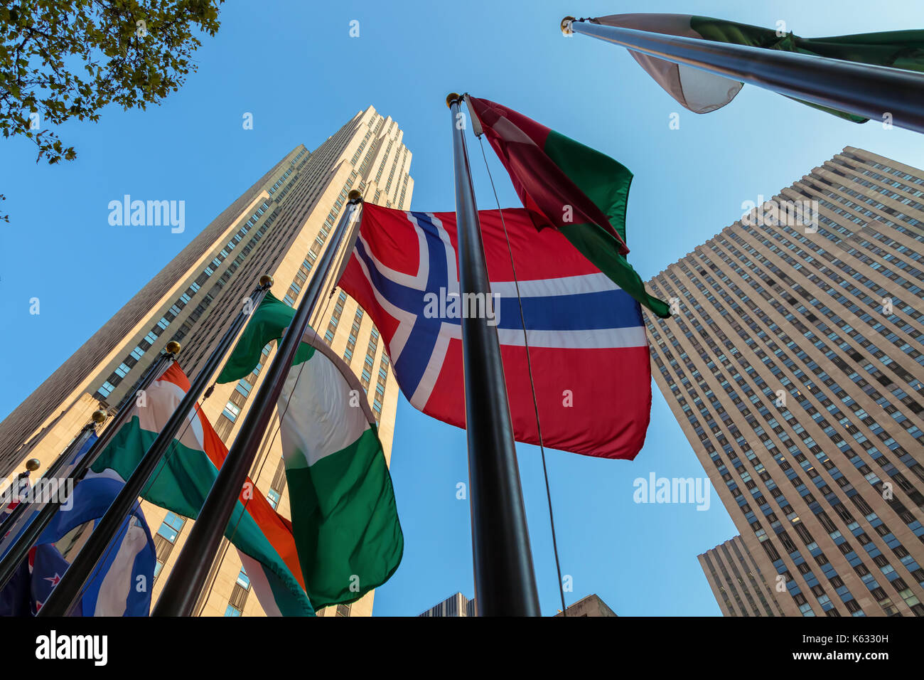 Flags of  the world nations fly at the Rockefeller Center with the Rockefeller Building in the background, New York City, New York Stock Photo