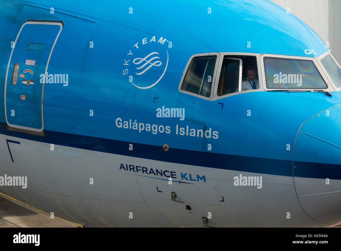 Front of KLM Boeing 777, PH-BQG, named Galapagos Islands, showing pilot through windscreen, making pre flight checks. At Schiphol airport, Amsterdam. Stock Photo