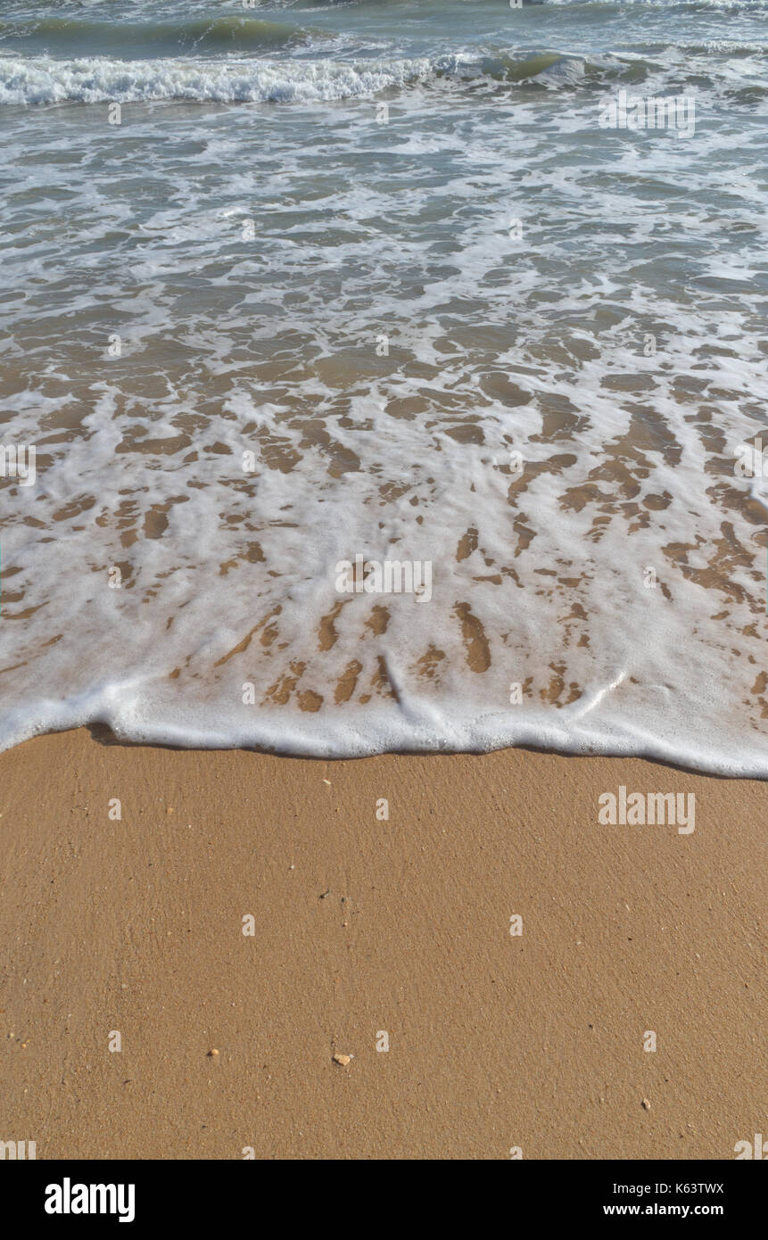 Sandy beach azure waves foam hi-res stock photography and images - Alamy