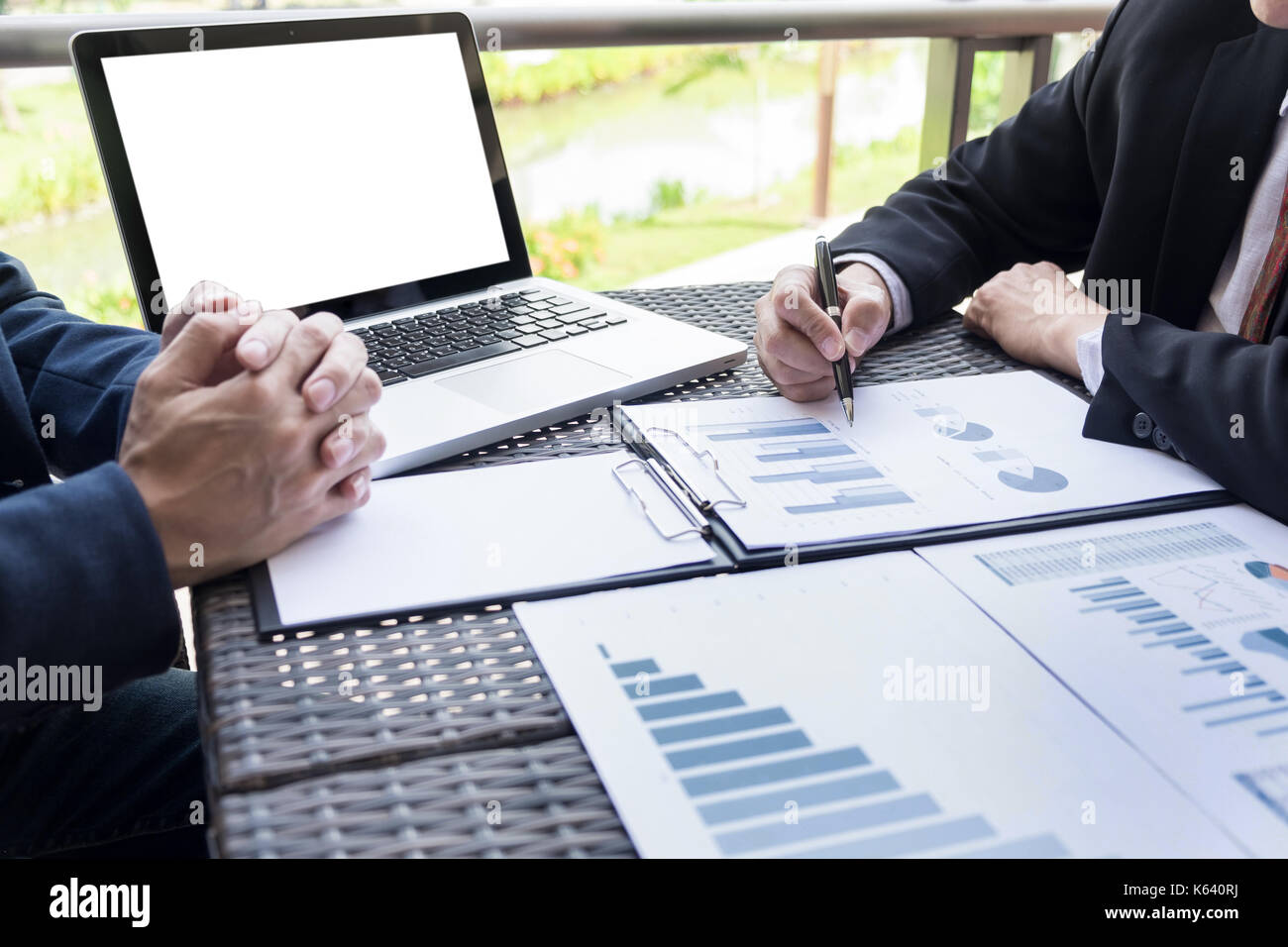 Business people discuss together about there work by graph document and