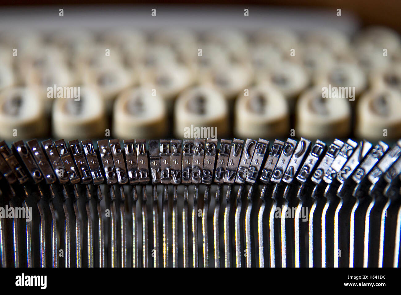 Close-up horizontal shot of metal printing letters using on a typewriters. Stock Photo
