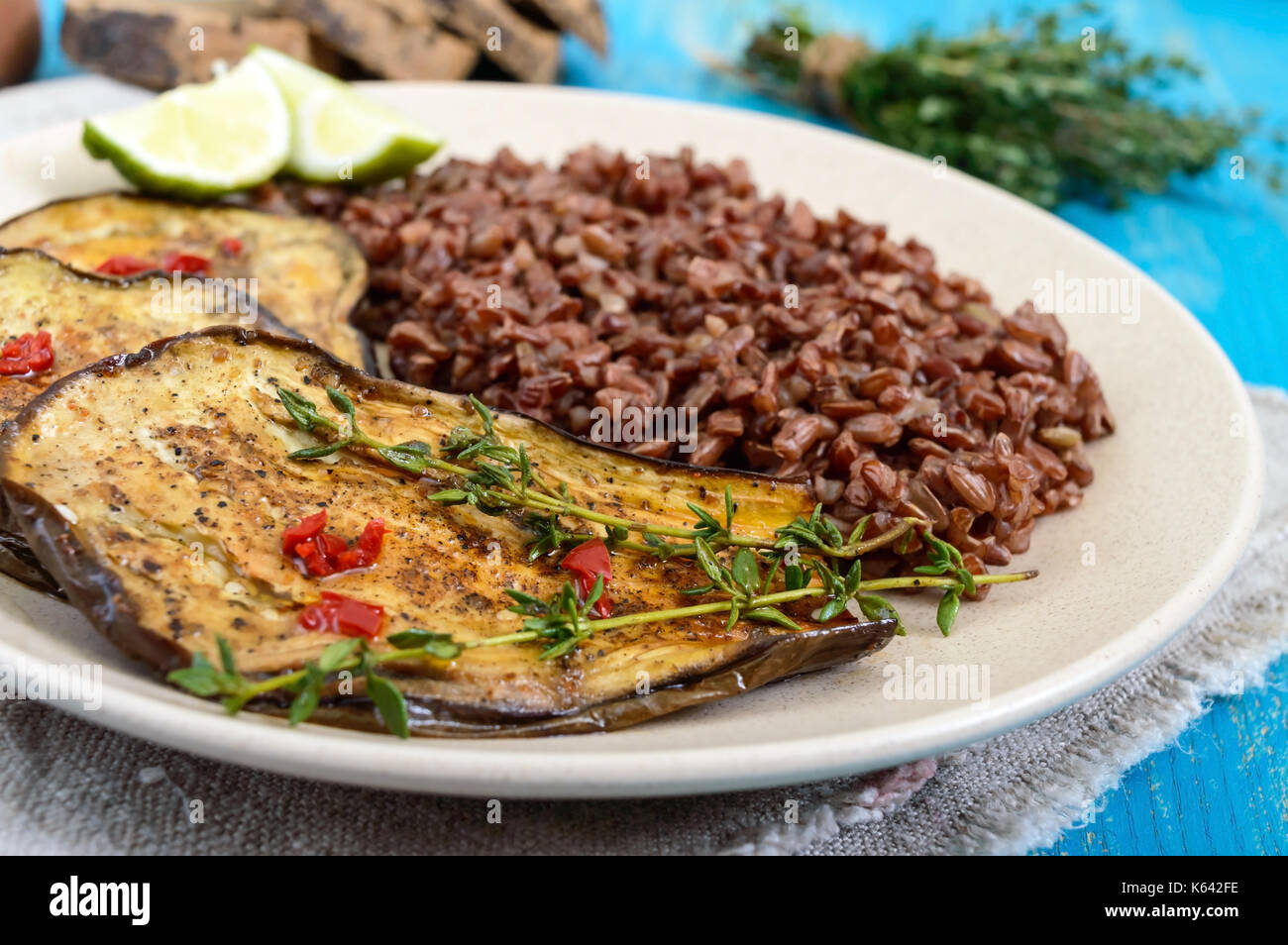 Baked slices of eggplant, butane red rice. Proper nutrition. Asian ...