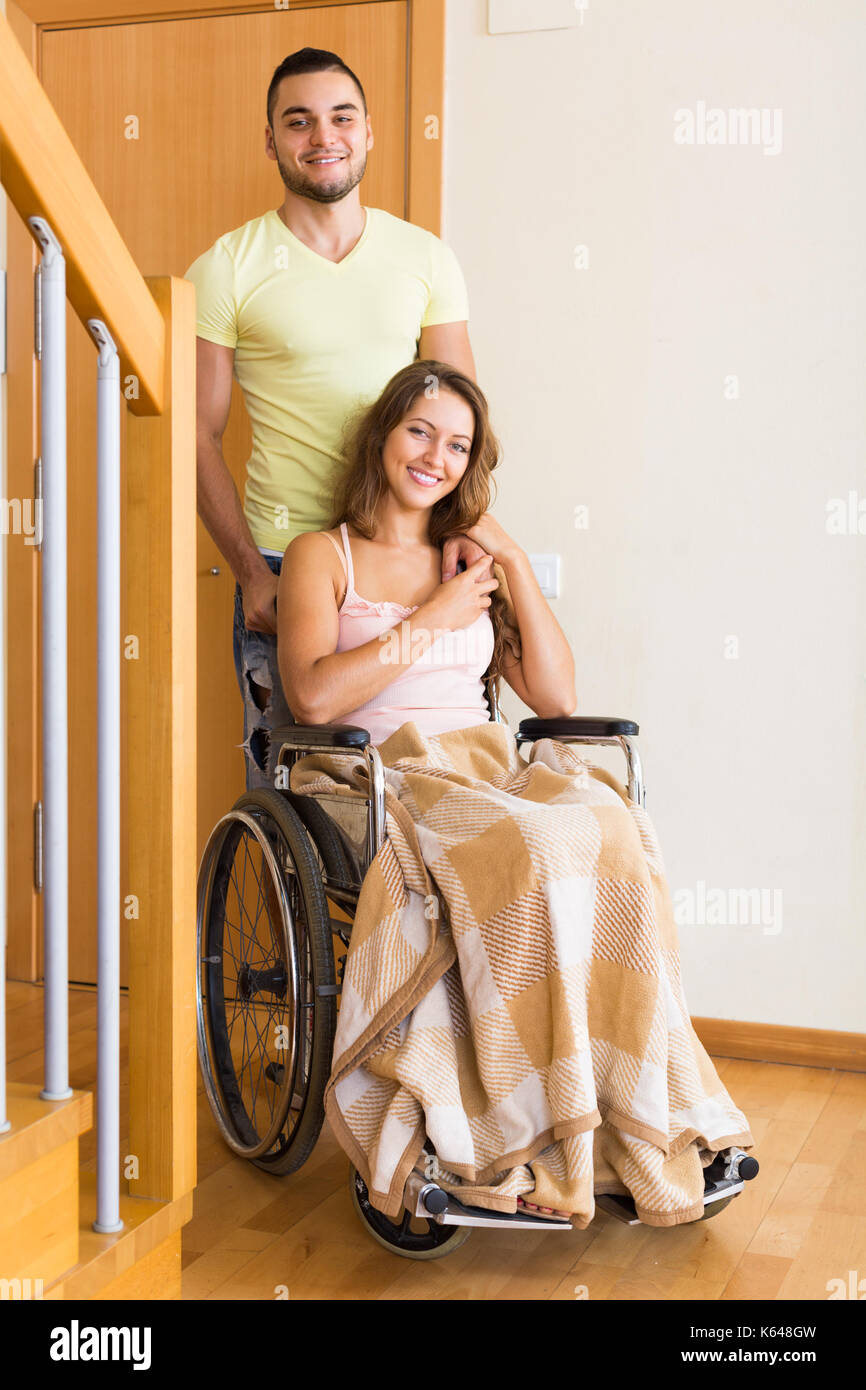 Positive young woman disabled husband hires stock photography and