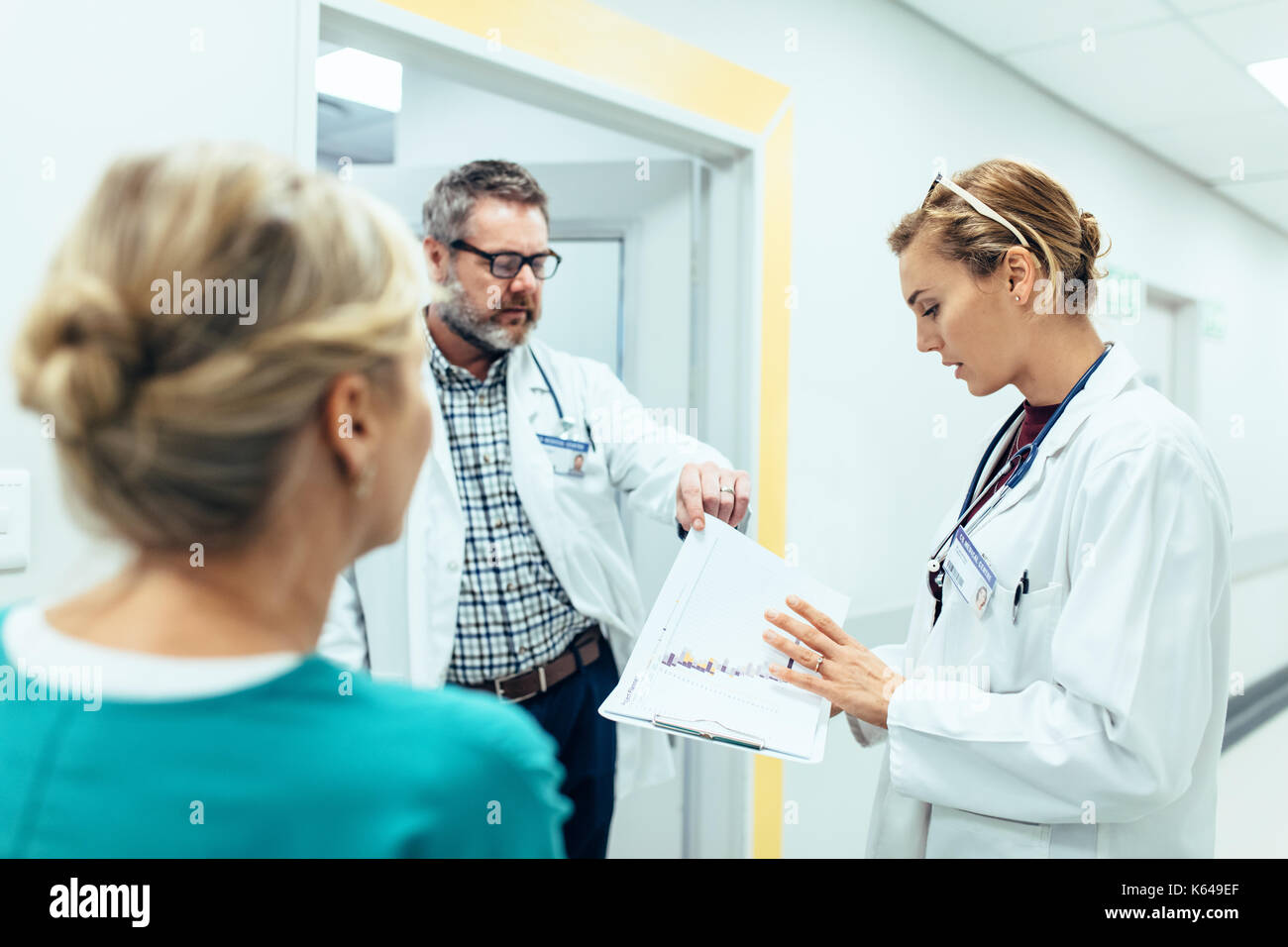 Doctors working in hospital and discussing over medical reports
