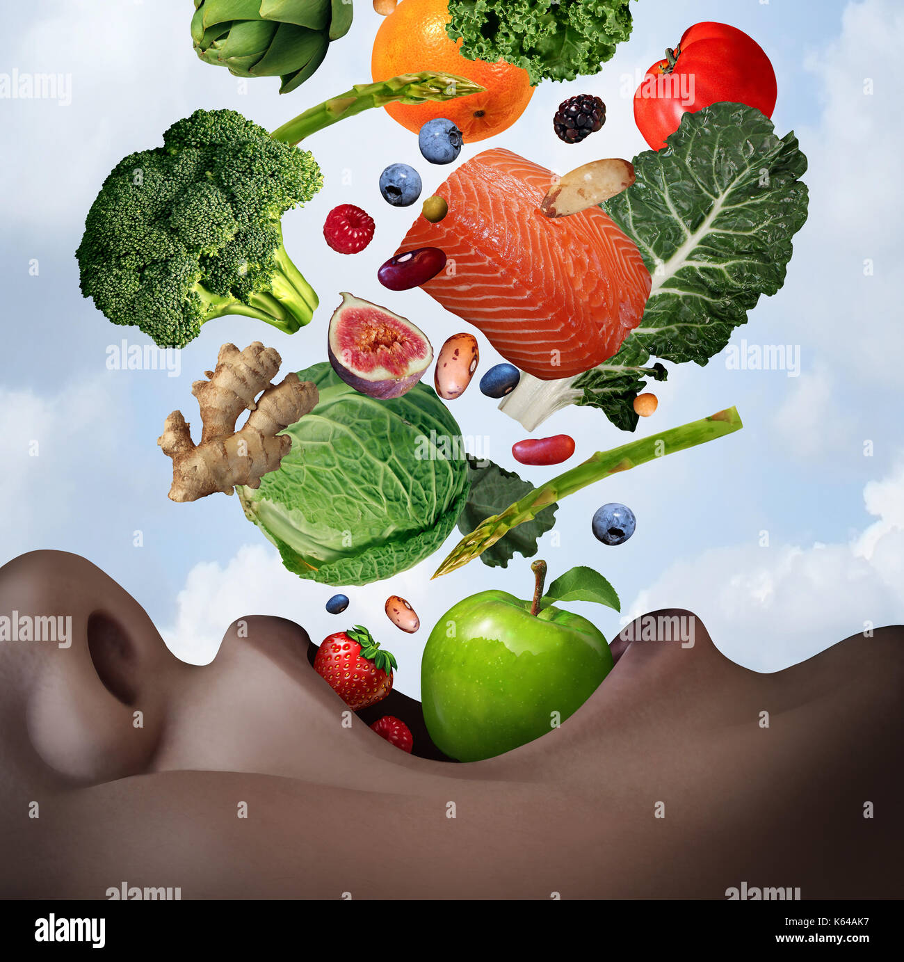 Healthy food diet concept as an open human mouth with nutritious fresh ingredients falling inside as salmon nuts berries beans vegetables and fruit. Stock Photo