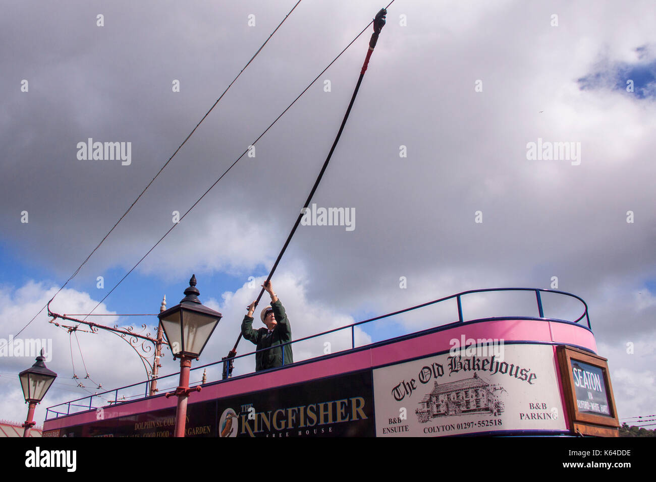 Seaton, Devon, UK. 11th Sept, 2017. UK Weather. A tram driver moves the trolley pole into place before taking tourists along the 3 mile route through the Axe Valley on the Seaton Electric Tramway, Devon.Sunshine will give way to stormy weather across the South West this afternoon. Credit: Photo Central/Alamy Live News Stock Photo