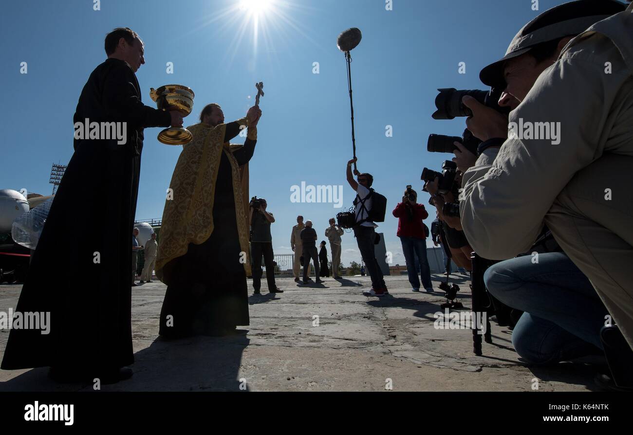 Baikonur, Kazakhstan. 11th Sep, 2017. Russian Orthodox priest, Father Serge during the traditional blessing of the Soyuz MS-06 spacecraft on the launch pad at the Baikonur Cosmodrome September 11, 2017 in Baikonur, Kazakhstan. International Space Station Expedition 53 crew American astronaut Mark Vande Hei of NASA, Soyuz Commander Alexander Misurkin of Roscosmos, and American astronaut Joe Acaba of NASA will launch aboard the rocket on September 13th. Credit: Planetpix/Alamy Live News Stock Photo