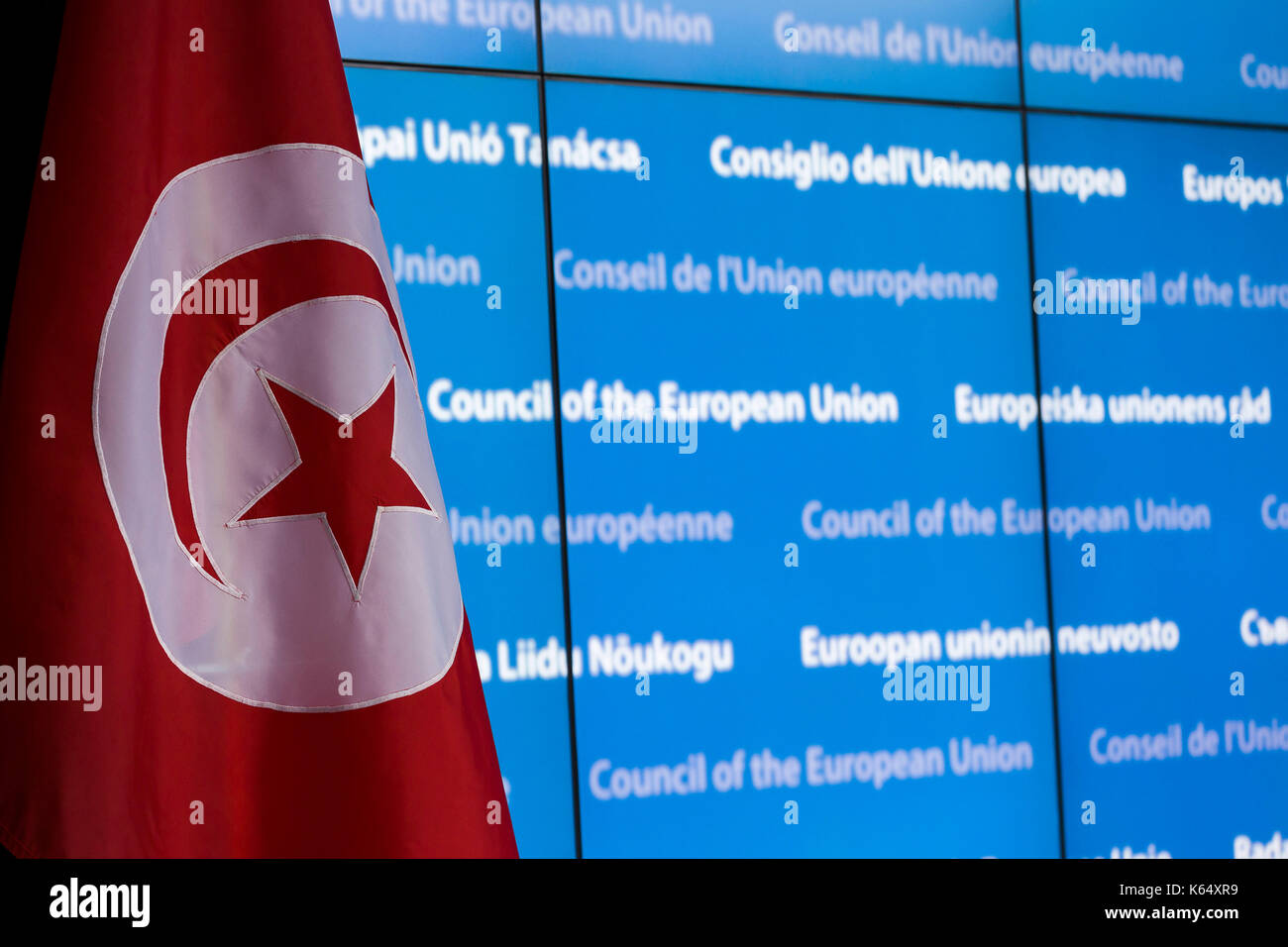 Belgium, Brussels, on 2015/03/17: Tunisian flag on a blue background, building of the Council of Europe, on the occasion of the EU-Tunisia Association Stock Photo