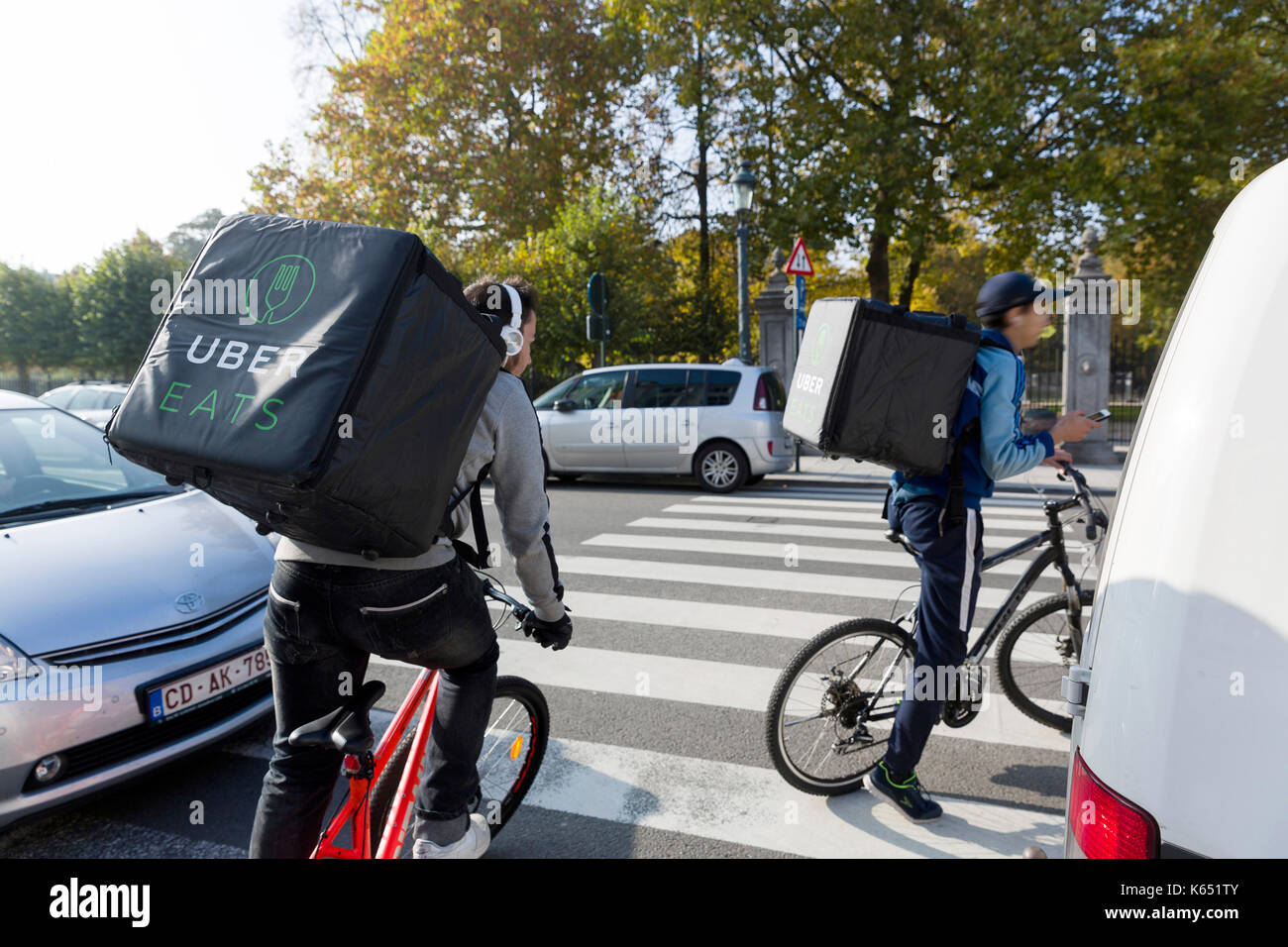 Belgium, Brussels: UberEATS, online meal ordering and delivery platform, courier riding a bike Stock Photo