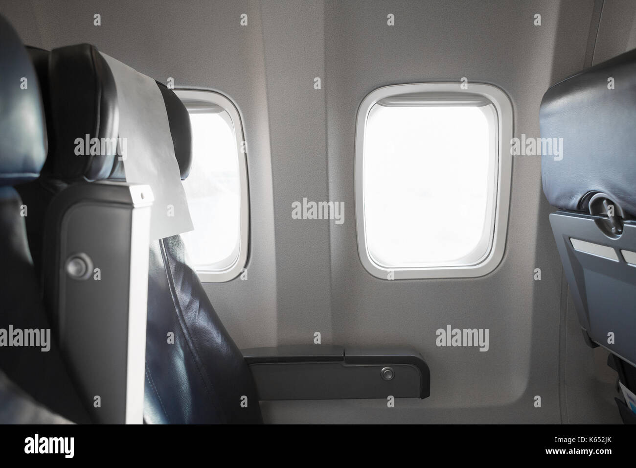 Airplane interior cabine and windows with empty passengers' seats Stock Photo