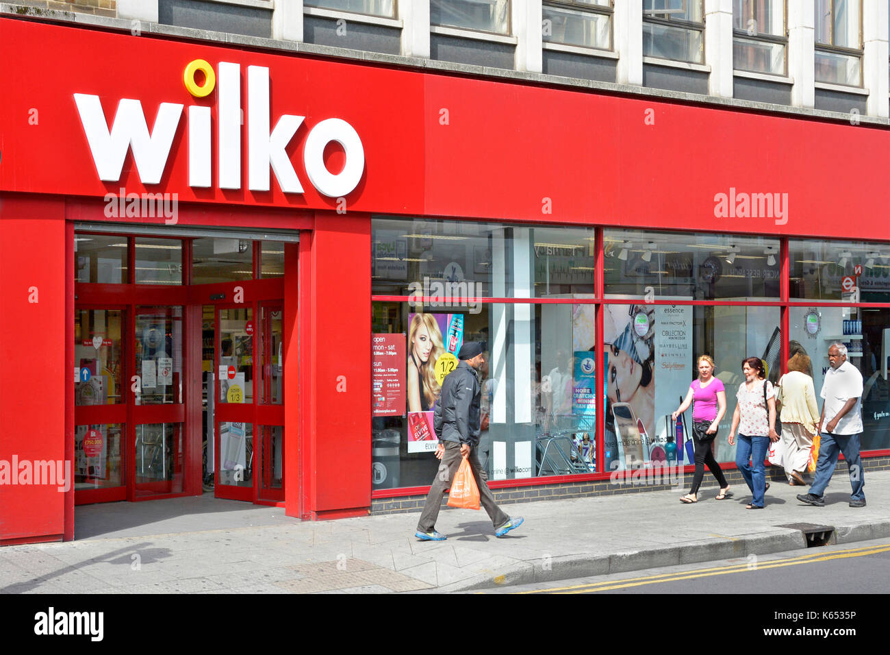 East Ham shopping high street & pavement Wilko store sign & shop front window re-branded from Wilkinson Hardware Stores Newham East London England UK Stock Photo