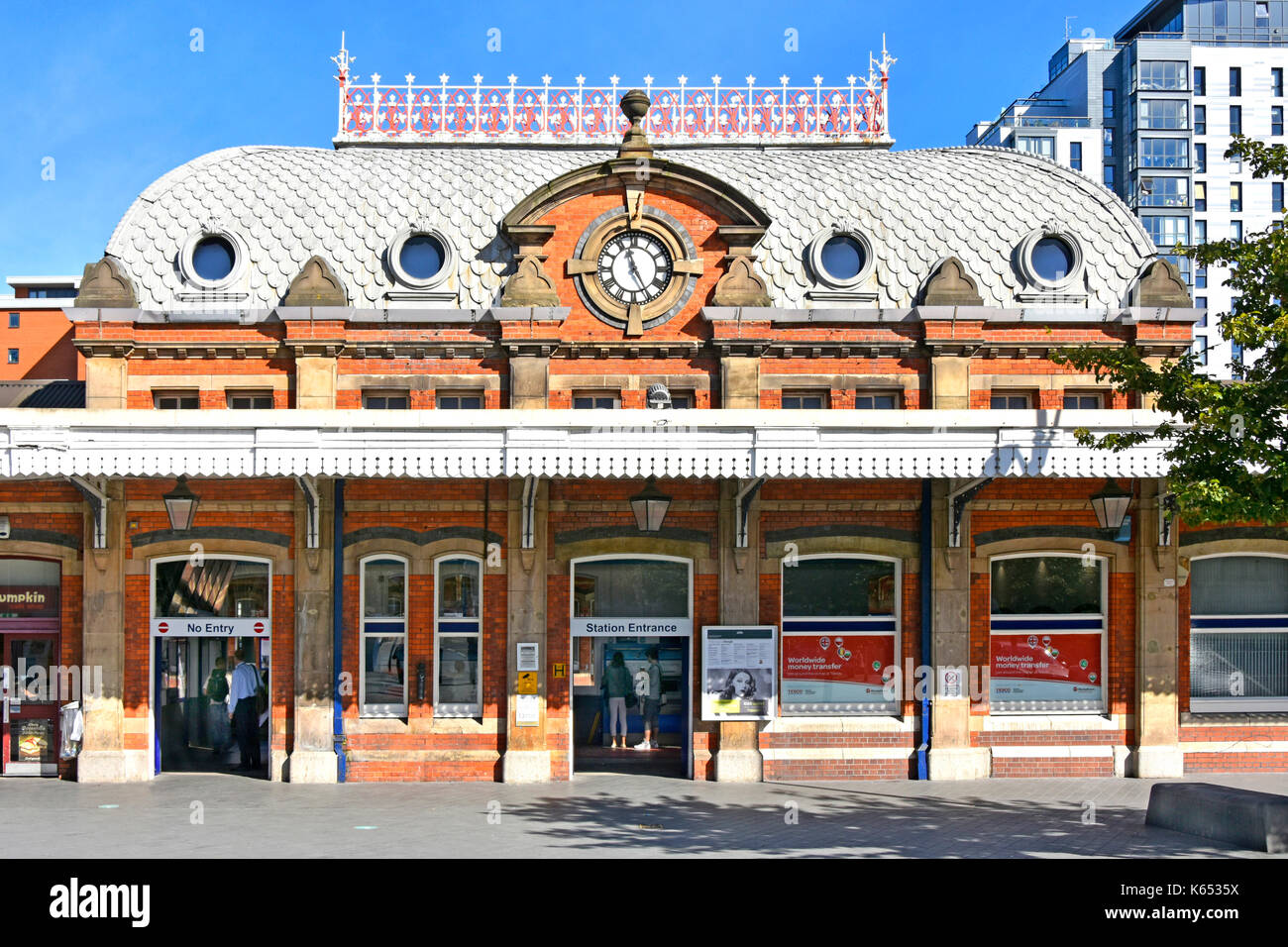 Slough town railway station & entrance showing the unusual Victorian scalloped roof tiles & decorative ironwork around the top of the building Stock Photo