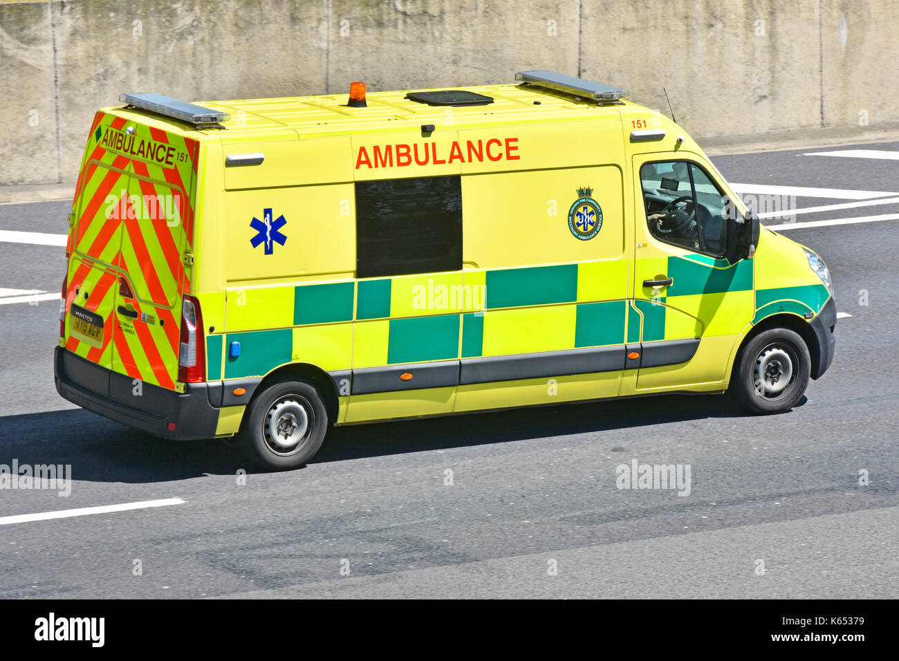 Private ambulance vehicle operated by UK Specialist Ambulance Service driving along M25 Motorway in Essex England UK Stock Photo