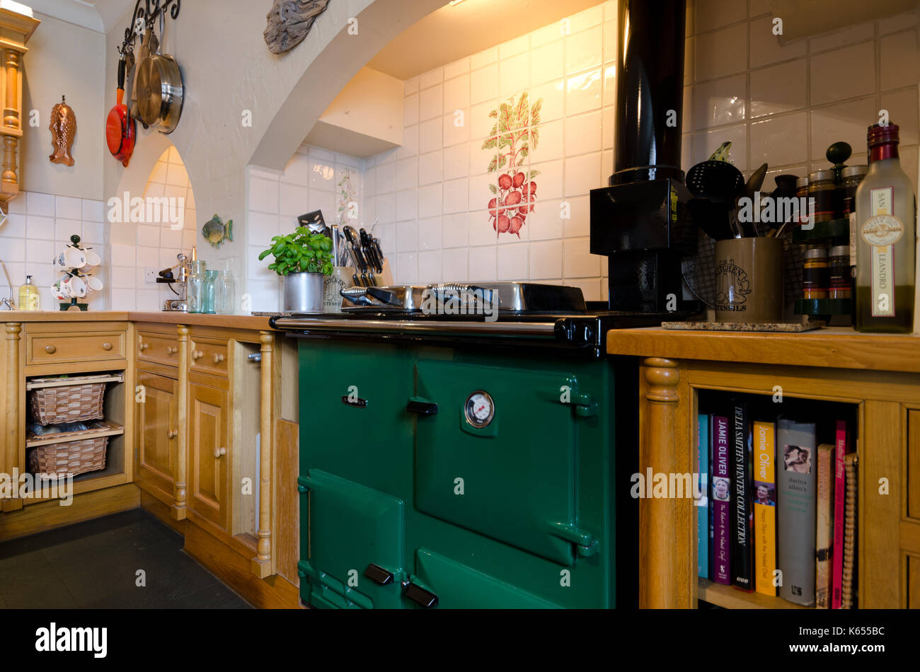 Green Aga type range cooker in kitchen Stock Photo