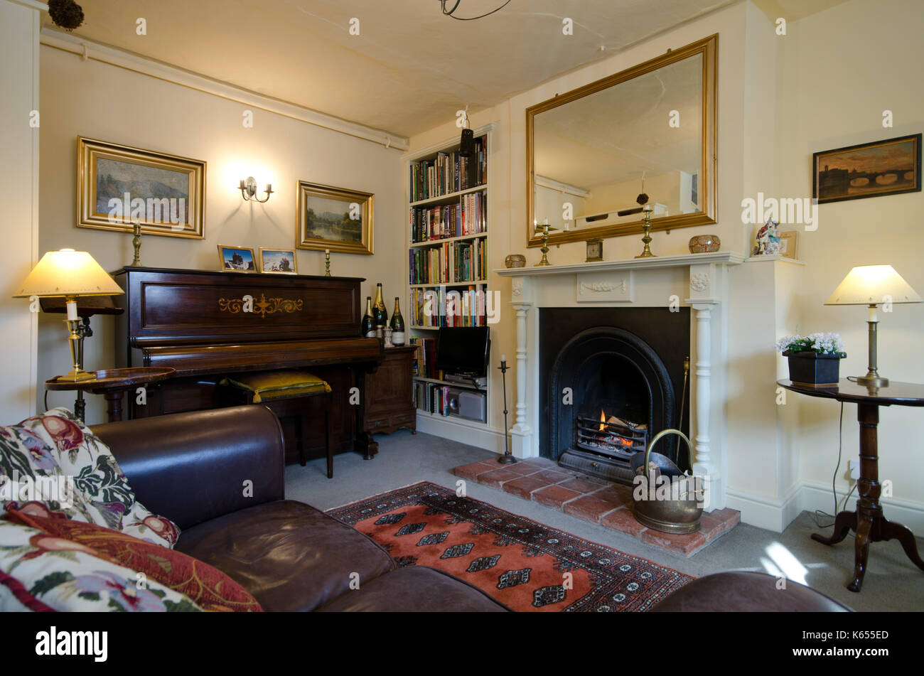 upright piano and open fireplace in sitting room Stock Photo - Alamy