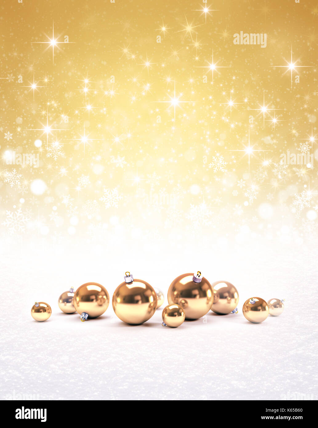 Golden christmas balls, falling snowflakes, white snow and bright light on a glittering gold colored background Stock Photo