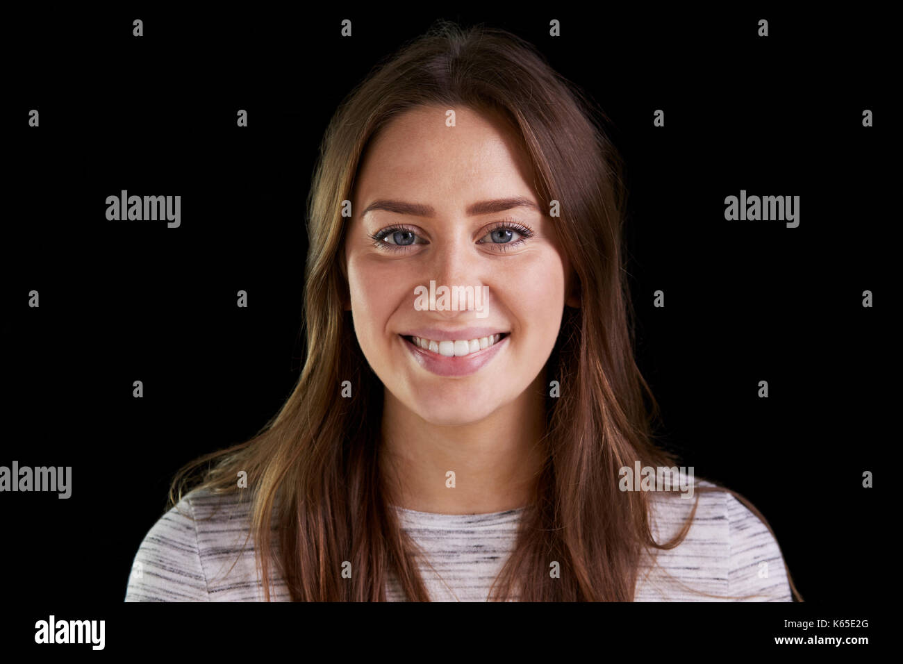 Head And Shoulders Studio Portrait Of Smiling Young Woman Stock Photo ...