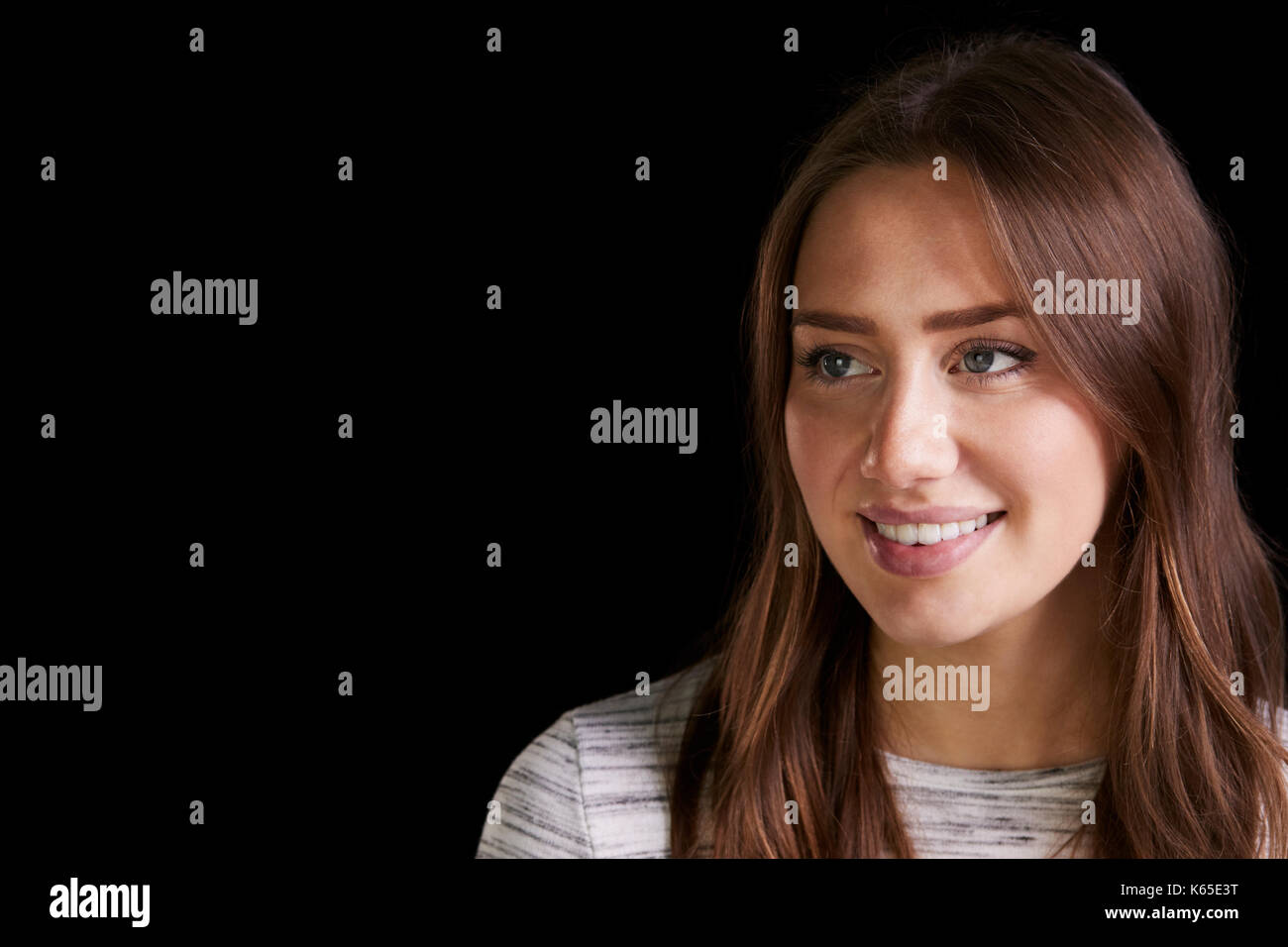 Head And Shoulders Studio Portrait Of Smiling Young Woman Stock Photo ...
