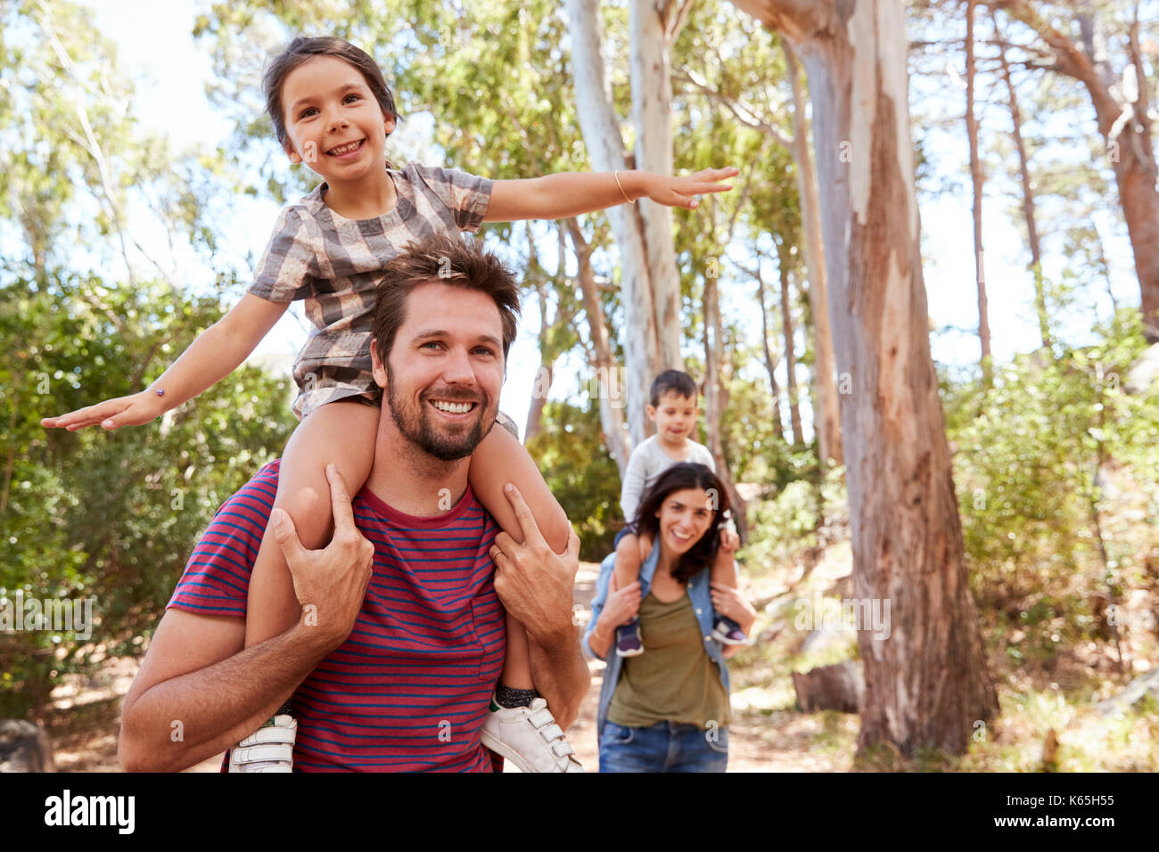 Children Riding On Parent's Shoulders On Countryside Walk Stock Photo ...