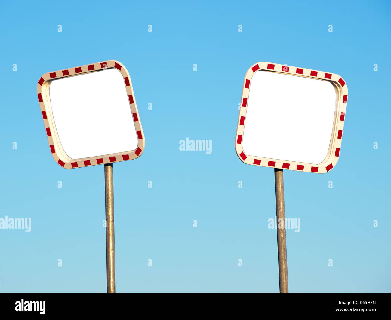 Two blank road mirrors on a blue sky background. Stock Photo