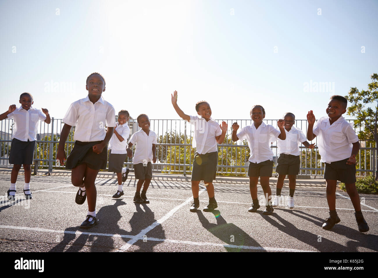 Elementary school kids having fun in school playground Stock Photo