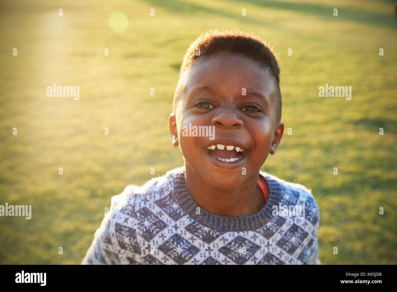 African elementary school boy laughing to camera outdoors Stock Photo ...