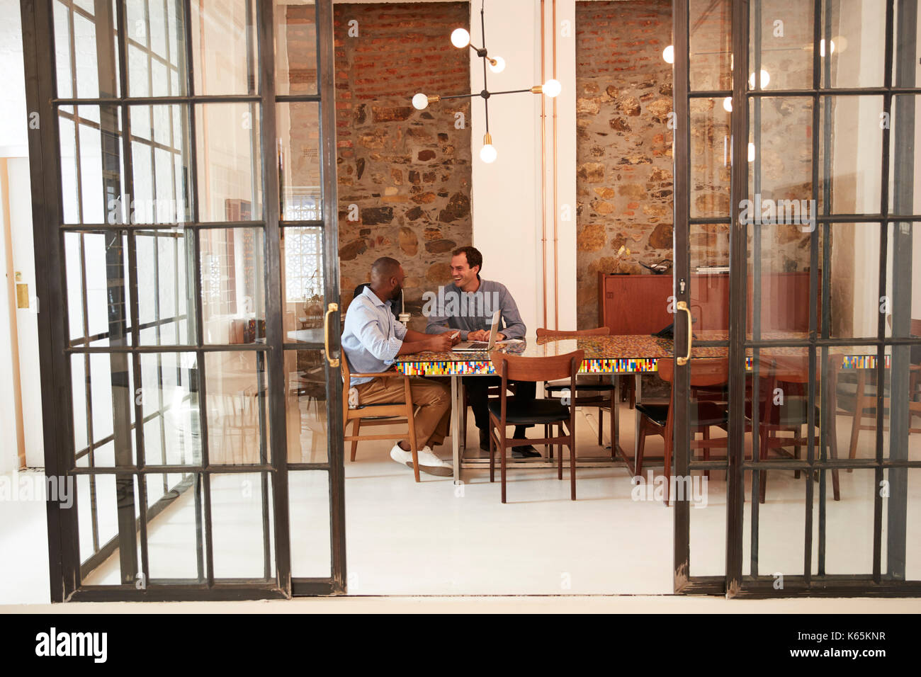 Two men talking in a room hi-res stock photography and images - Alamy