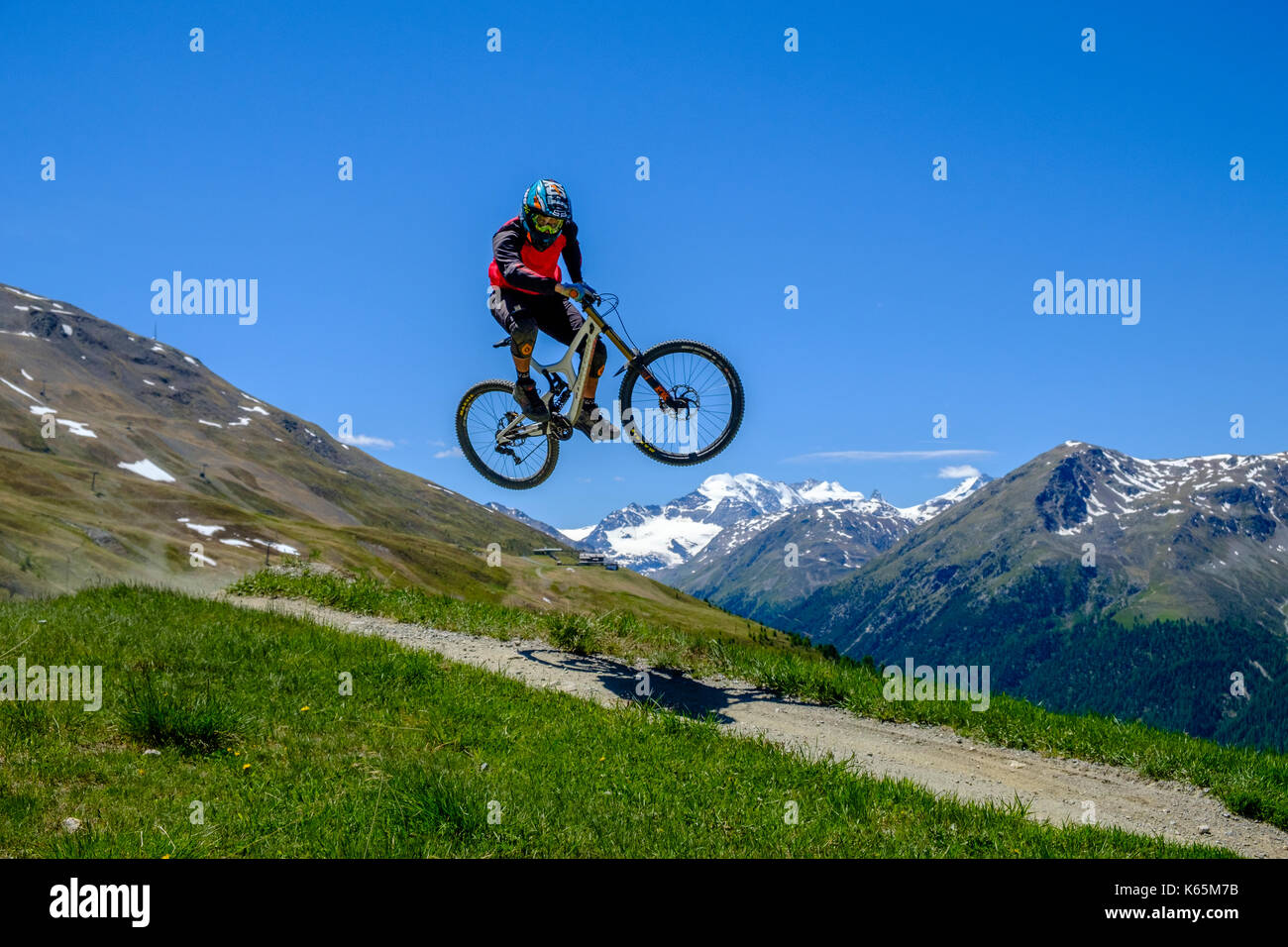 Downhill cyclist in action jumping in the Motolino Bike Park Stock Photo