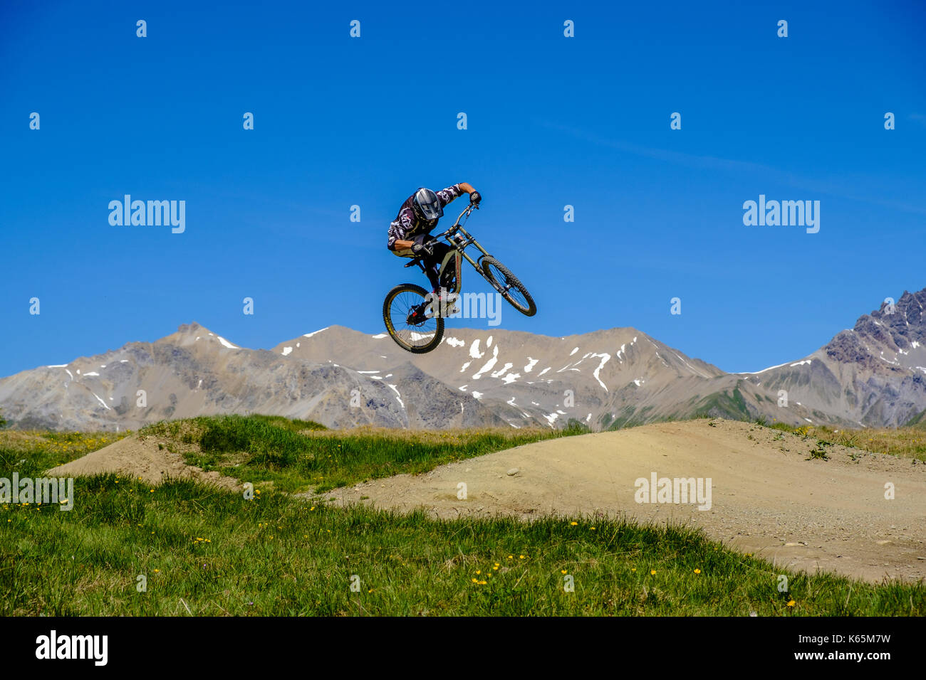 Downhill cyclist in action jumping in the Motolino Bike Park Stock Photo