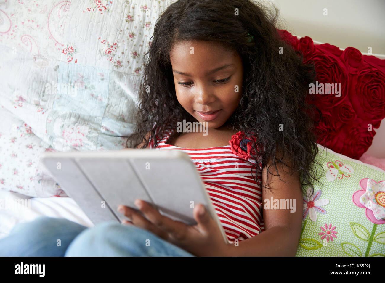 Young Girl Lying On Bed Using Digital Tablet Stock Photo - Alamy