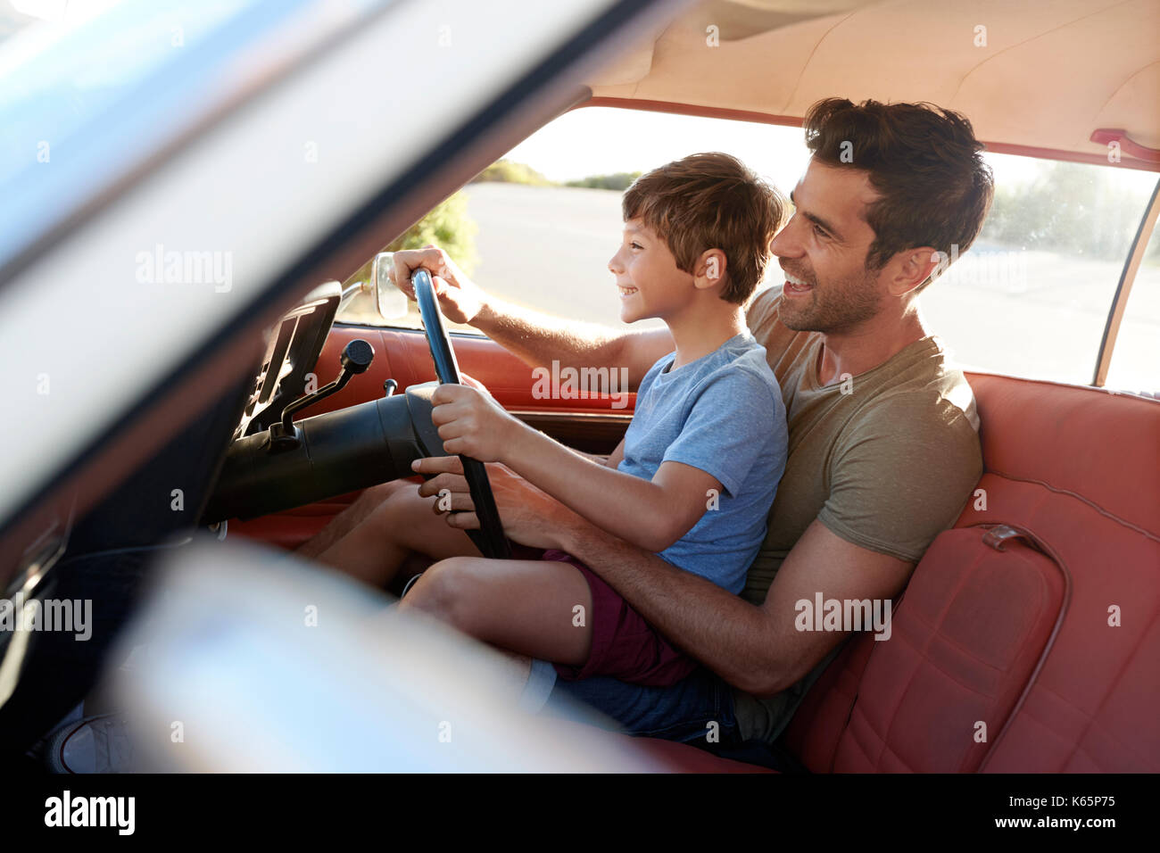 Father Teaching Young Son To Drive Car On Road Trip Stock Photo - Alamy