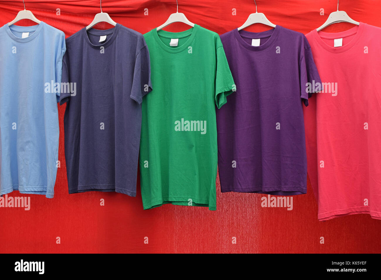 Short sleeve cotton t-shirts in various colors for sale at street market. Stock Photo