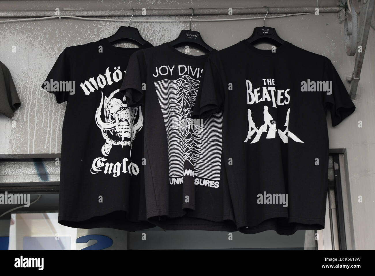 ATHENS, GREECE - AUGUST 4, 2016: Rock music t-shirts printed with band logos for sale. The Beatles, Joy Division and Motorhead designs. Stock Photo