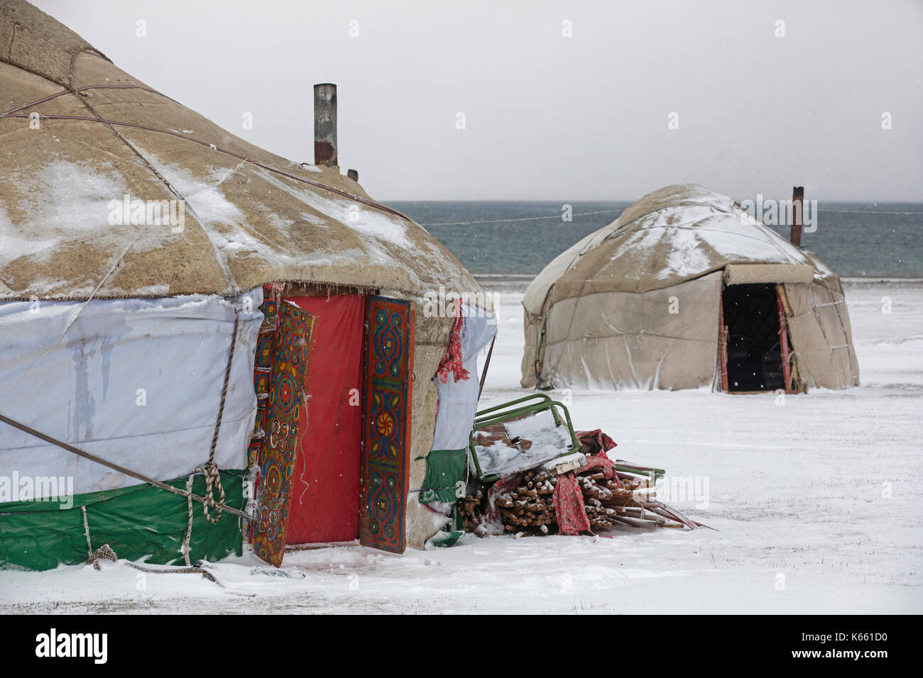 Yurts in traditional Kyrgyz yurt camp during snow storm along Song Kul / Song Kol lake in the Tian Shan Mountains, Naryn Province, Kyrgyzstan Stock Photo