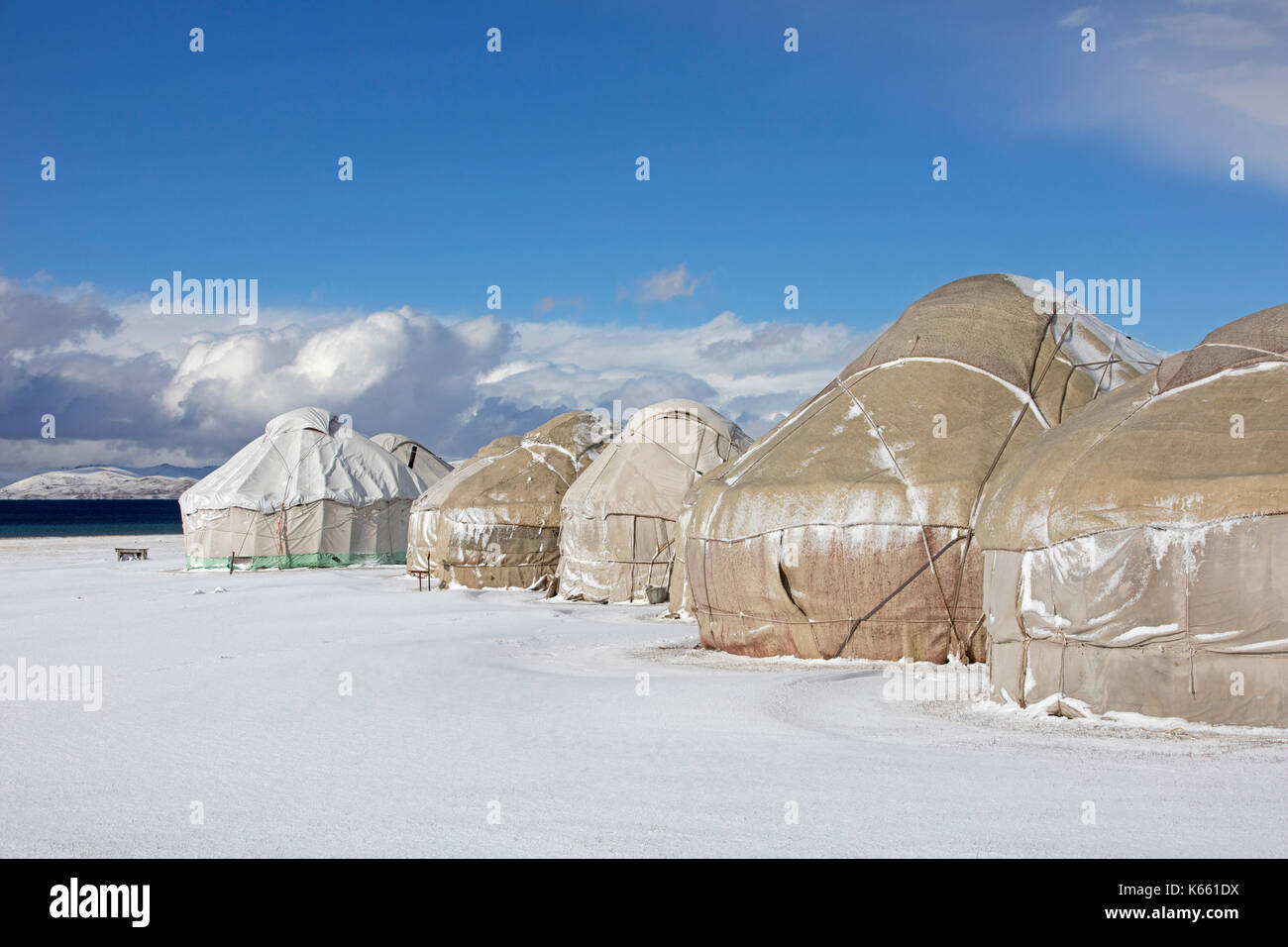 Yurts in traditional Kyrgyz yurt camp in the snow along Song Kul / Song Kol lake in the Tian Shan Mountains, Naryn Province, Kyrgyzstan Stock Photo
