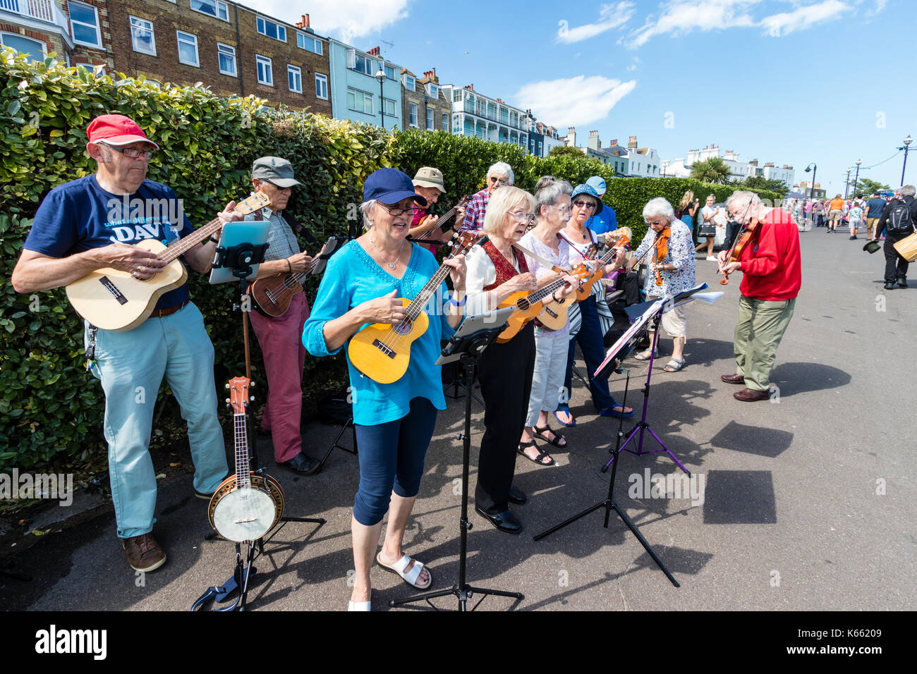 England, Broadstairs folk week. Members of the U3A, a group for elderly people, giving a ukulele concert on the seafront promenade in the summertime. Stock Photo