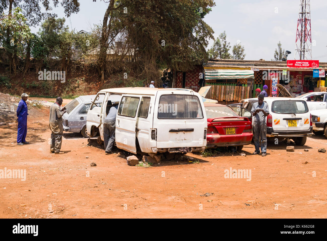 Mechanics working on vehicles by roadside, Kenya Stock Photo