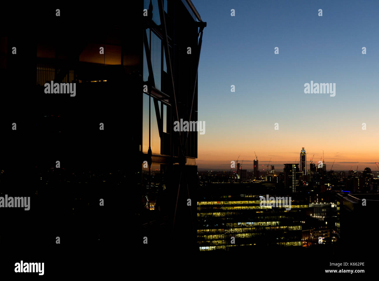 Modern stylish city landscape at dusk with glass and steel building Stock Photo