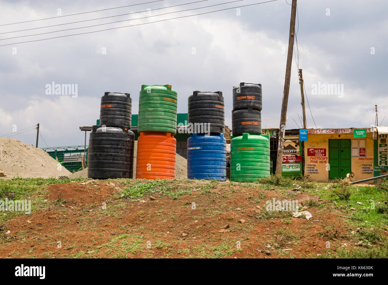 Large plastic water storage containers on display by roadside, Kenya Stock Photo