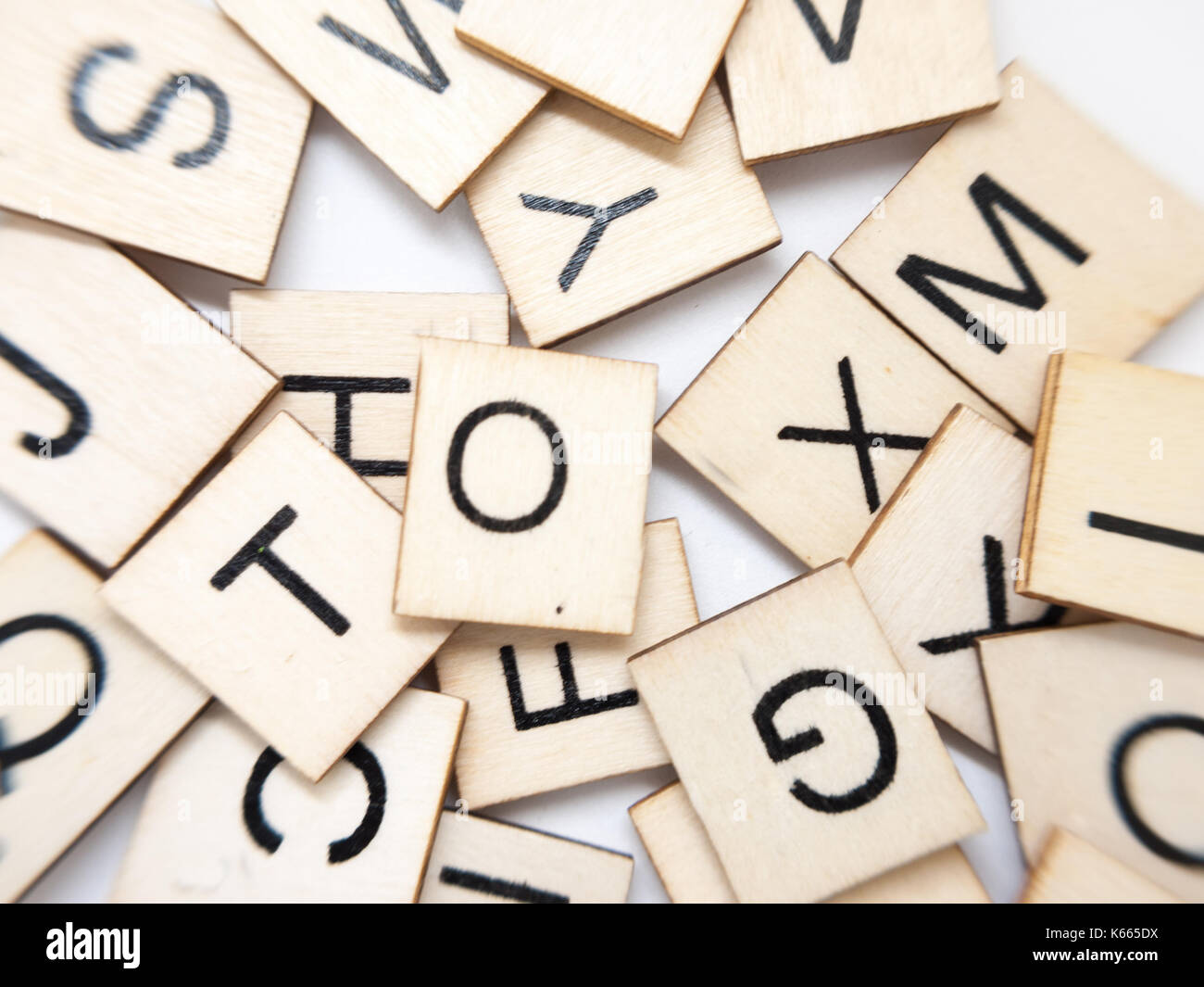 A macro image of a messy pile of wooden letters. Stock Photo