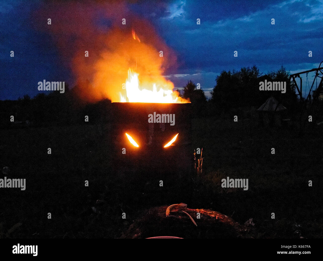 the fire burns in the night in a barrel, Russia Stock Photo