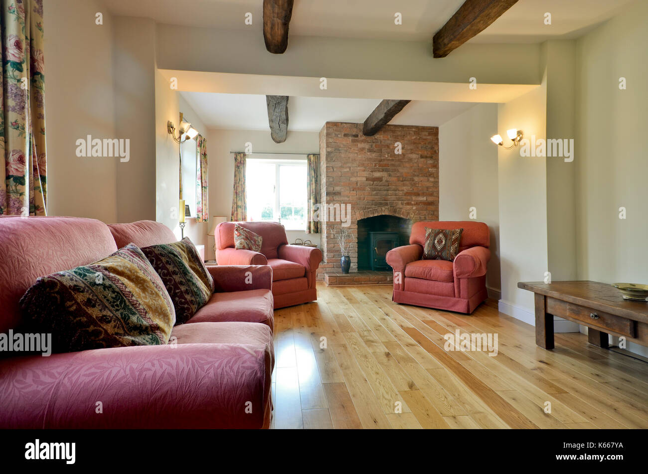Small cottage sitting room with brick fireplace Stock Photo - Alamy