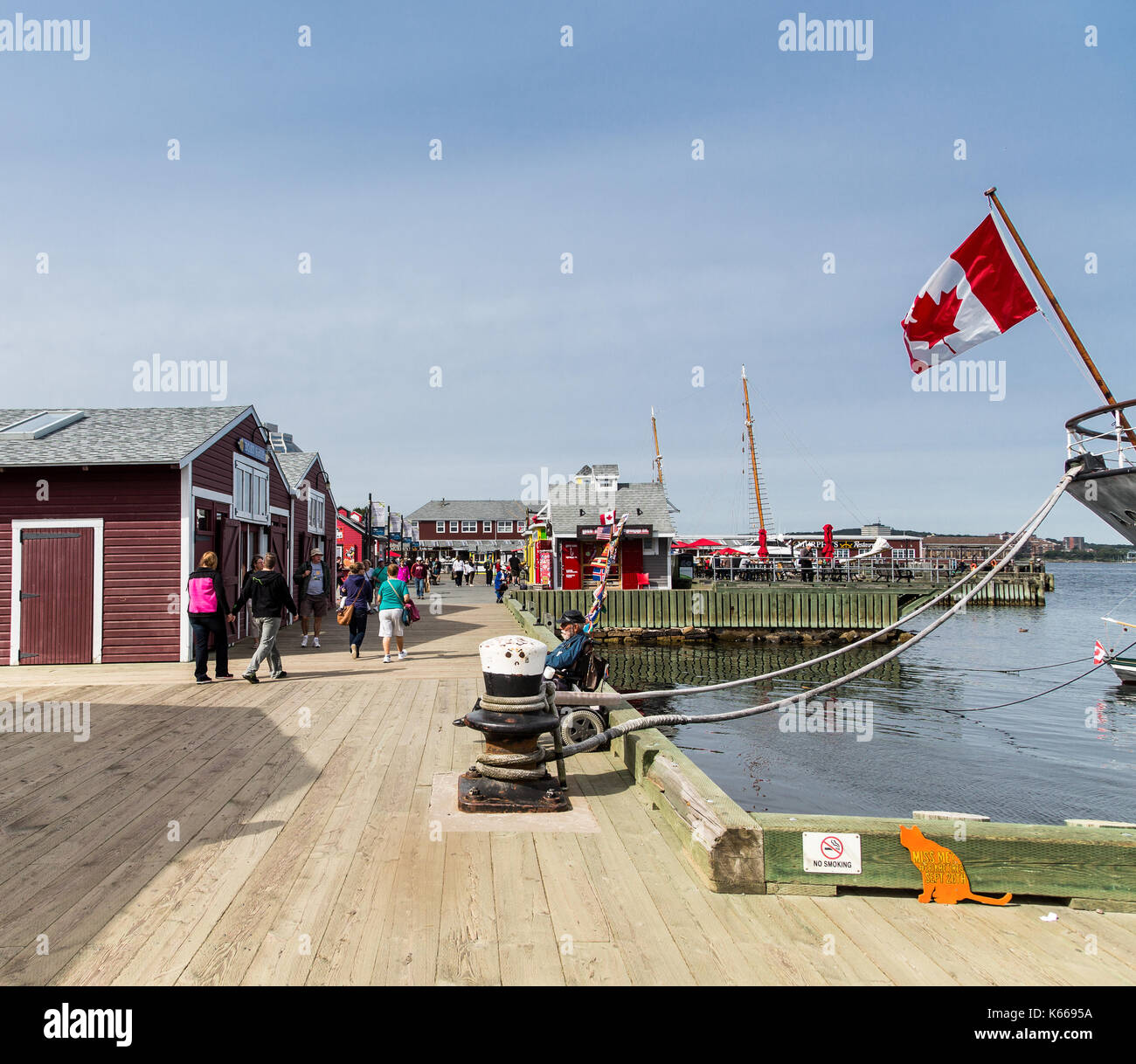 Tourists walking along the old waterfront in Halifax Harbour Stock Photo