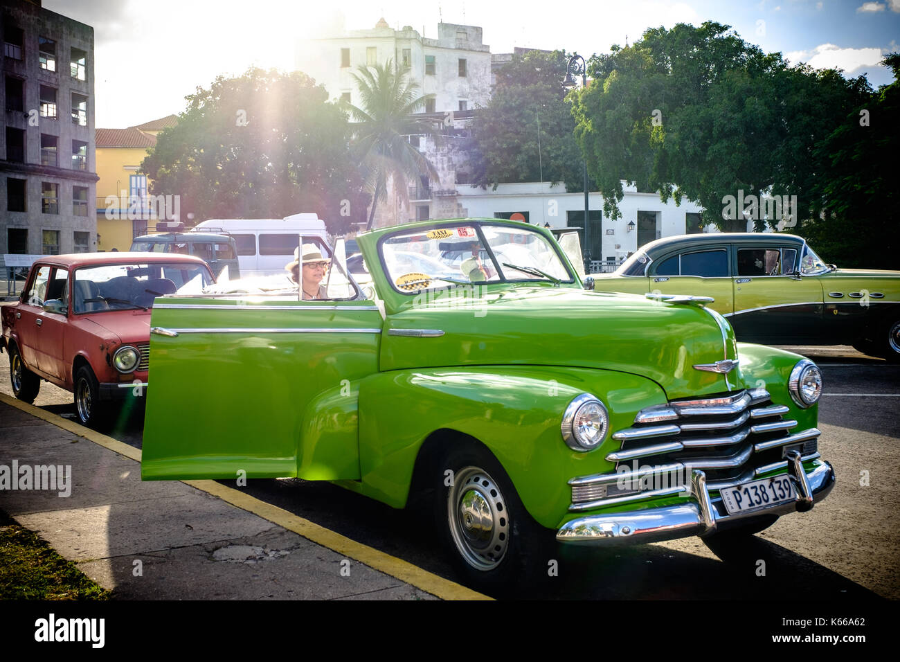 Havana, Cuba. Tourists riding in a classic American car along Havana's malecon. Stock Photo