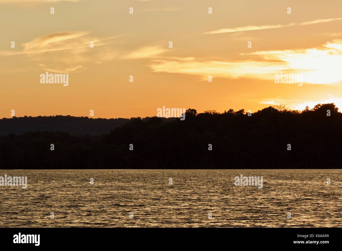 Isolated image of an amazing sunset on a lake Stock Photo - Alamy