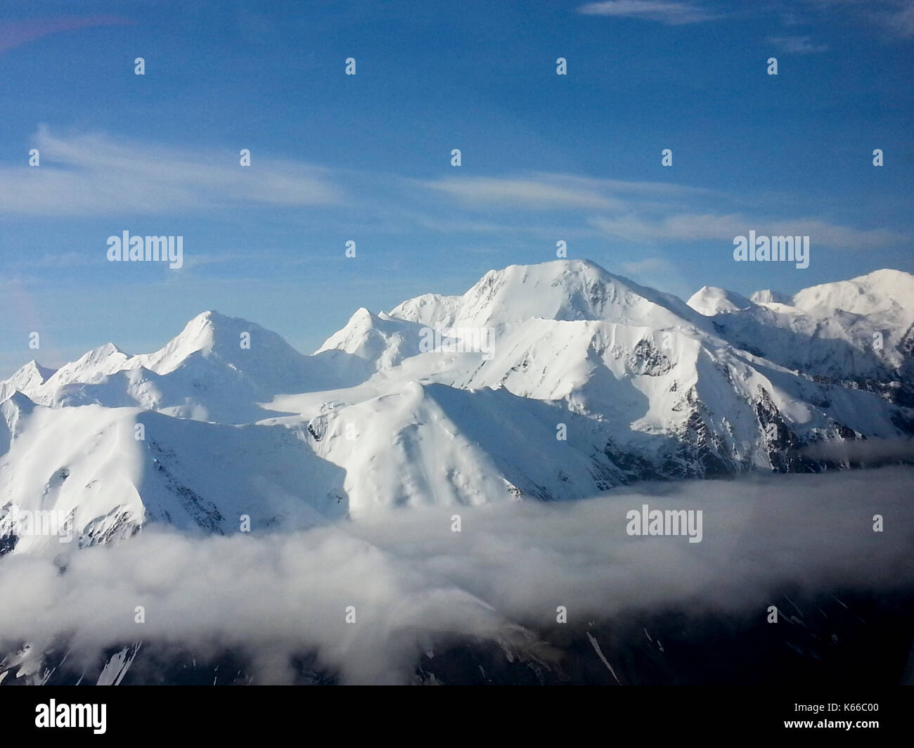 AERIAL VIEW FROM TOURING AIRPLANE OF SNOW CAPPED MOUNTAINS, ALASKA ...