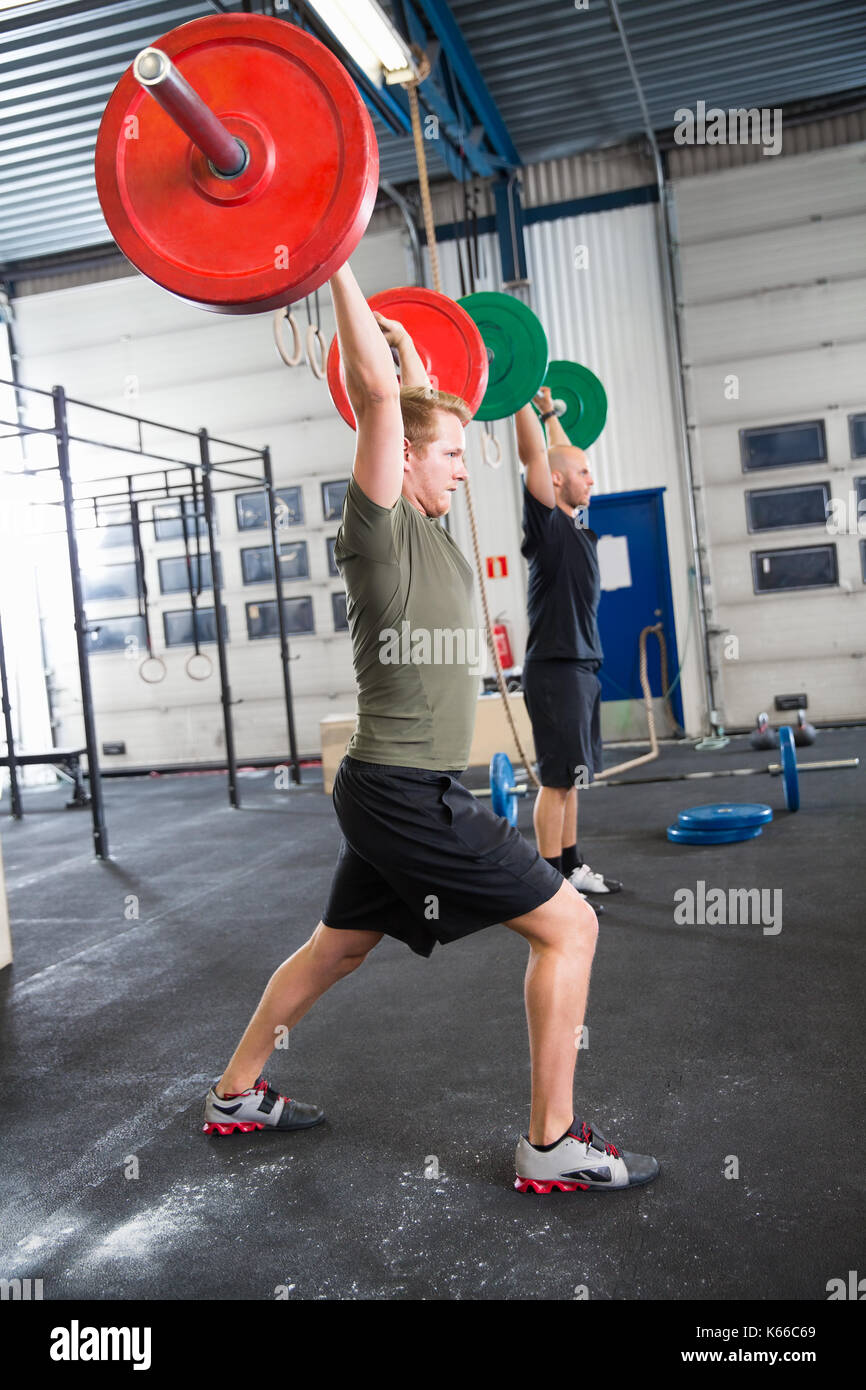 Male Athletes Lifting Weights In Health Club Stock Photo