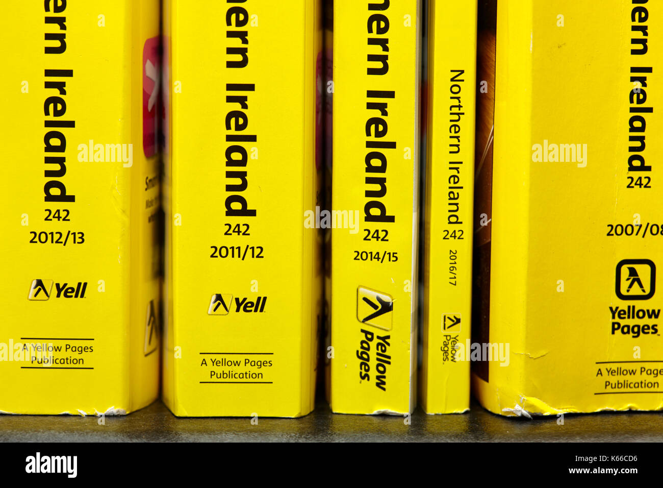 decreasing size later smaller thinner versions of the yellow pages classified telephone directory paper edition uk Stock Photo