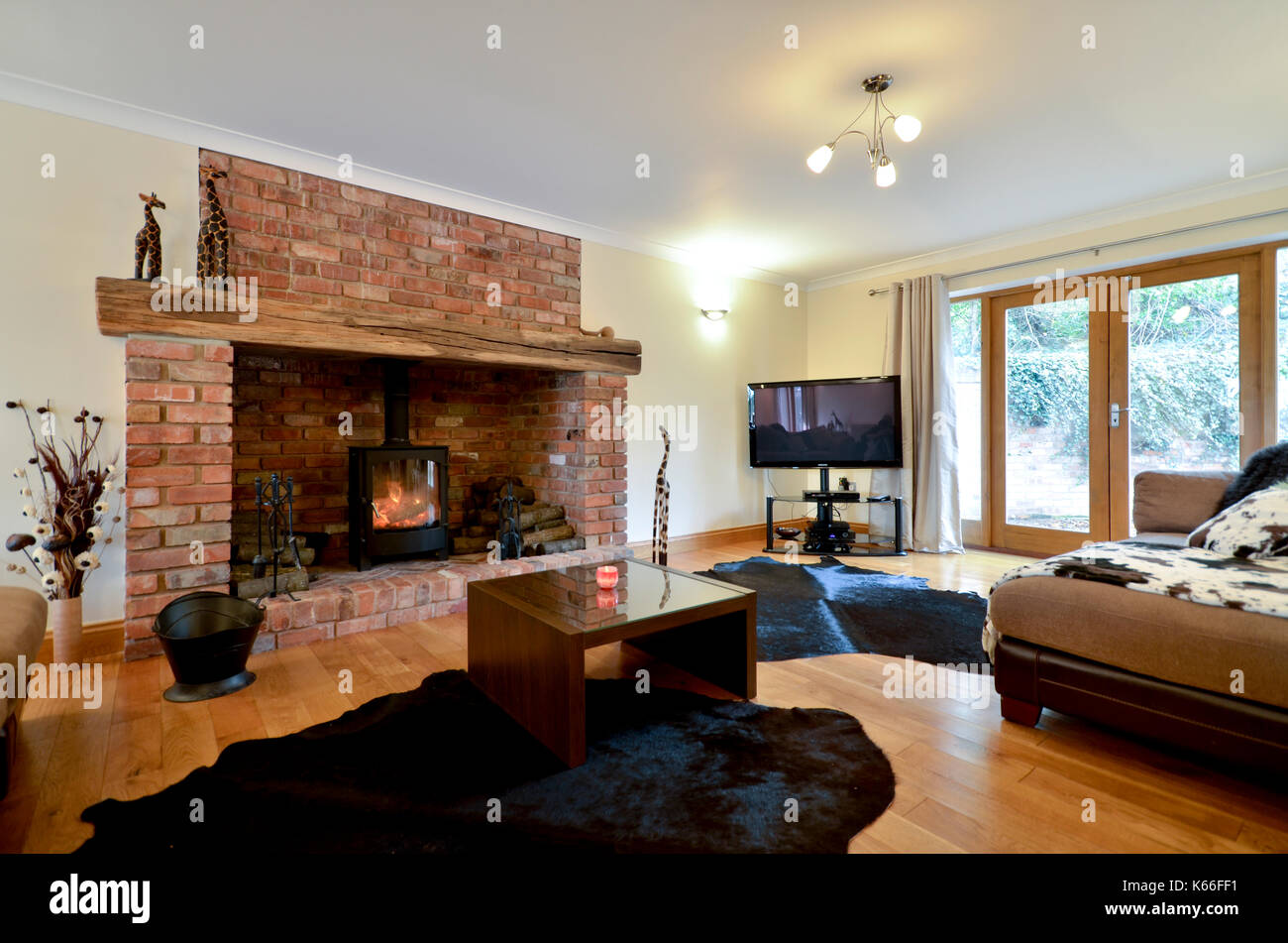 Large brick fireplace with wood burner Stock Photo